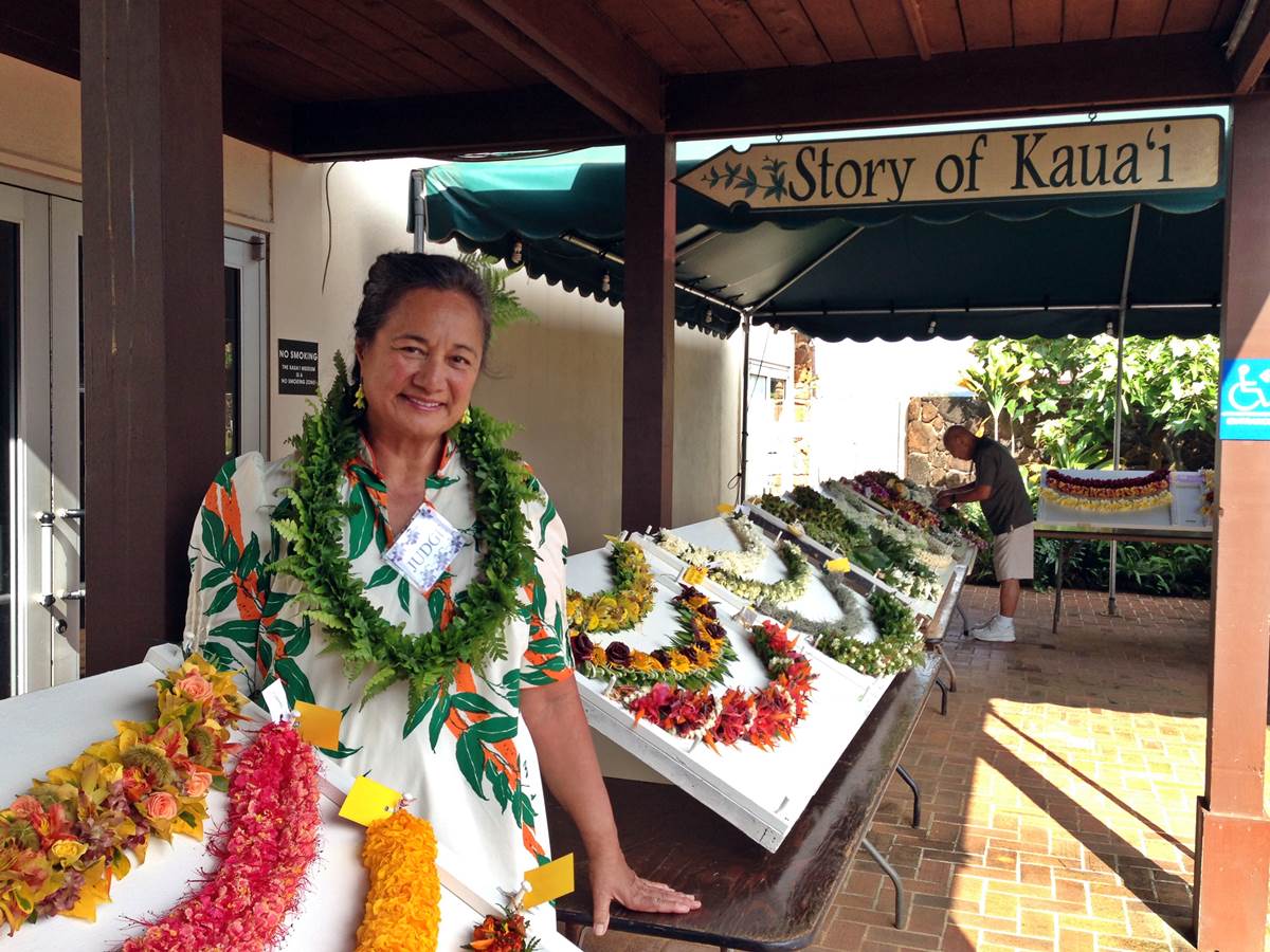 Woman in lei stand.