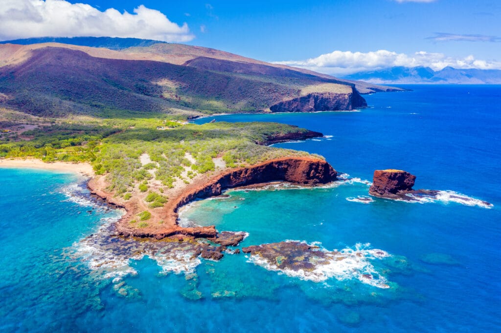 Aerial view of Lanai, Hawaii featuring Hulopo'e Bay and beach, Sweetheart Rock (Pu'u Pehe), Shark's Bay, and the mountains of Maui in the backgroundhateii hawiia hawaii. hawaiii hawiaii hwaii hawaai hawall hawii hawwai hawwaii hawwii hiwaii haiwaii hawia hawwi 1993615100